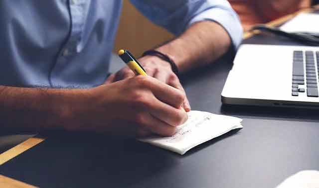 A man writing notes